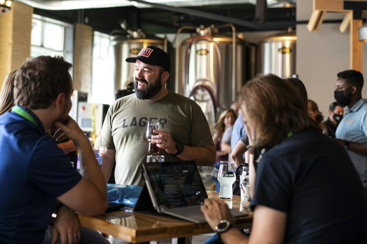 Group conversing while sitting at a table with drinks