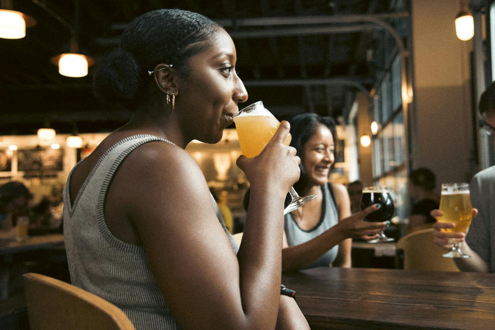 Person Drinking Beverage While Sitting Down