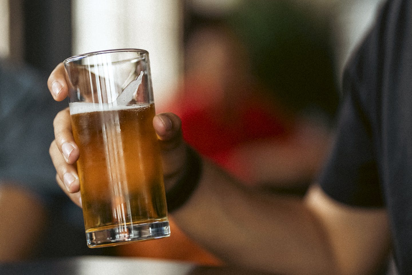 Man Holding Beer in Close Up